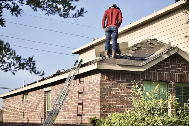 Professional roofer working on a residential roof in Line Lexington